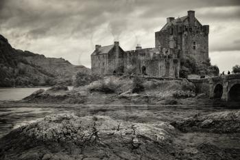 Eilean Donan Castle in black and white at low tide in the Highlands, Scotland