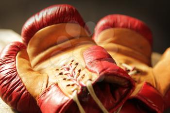Retro pair of red and yellow boxing gloves lying on a table.  