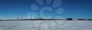 Panorama of windmills in field during winter season