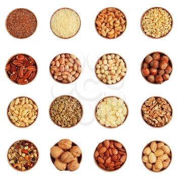 Collection of nuts, seeds in a wood bowl on white background