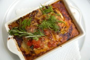 Top view of a tomato lasagna in a white plate