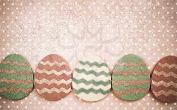 old style decorated felt easter eggs on a  polka dots background with a intentional vignetting and frame