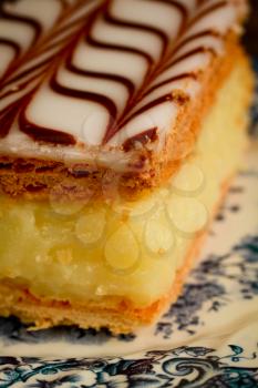 Close up of a millefeuille, french pastry with custard on wooden table
