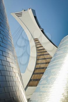 MONTREAL  CANADA - SEPT 05: Olympic stadium between modern buildings on september 05, 2014 in MONTREAL