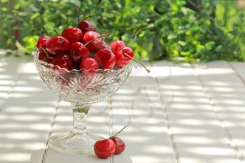Fresh cherry in a clear bowl on a table