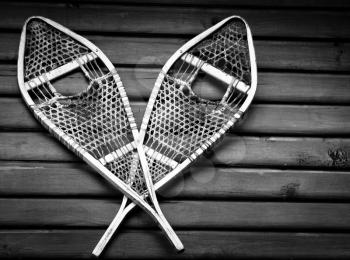 Vintage snowshoes hanging on a wall in black and white version