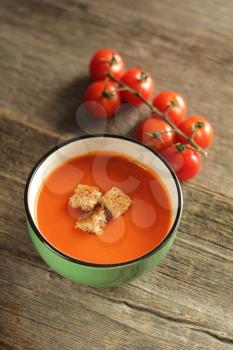 Tomato soup on a rustic background
