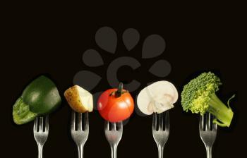 Variation of fresh vegetables on a black background, zucchini, potato, tomato, mushroom and broccoli
