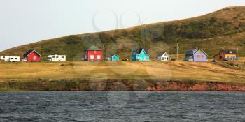 Colourful house along the water on magdalen island in Canada