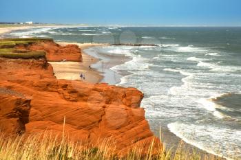 Red cliff in Havre Aubert with waves in the ocean in the St-Lawrence golfe