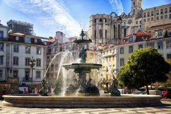 One of the two baroque fountains erected in 1889 with mermaids at Rossio square in Lisbon, Portugal.   Image taken from street.