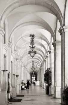 Arcades with lamps at commerce square in Lisbon, Portugal