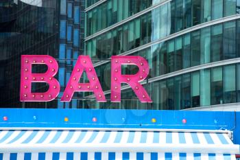 Pink retro styled bar sign in London, UK.