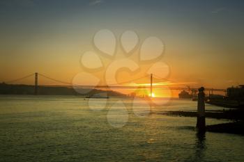 Beautiful sunset on the 25 de Abril Bridge over the Tagus river in Lisbon
