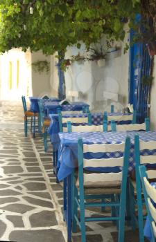 Blue chairs and table on a terrace in Greece
