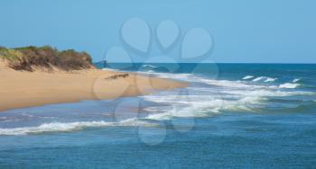 Nice white beach with waves and a blue sky at Lake Entrance in Victoria in Australia