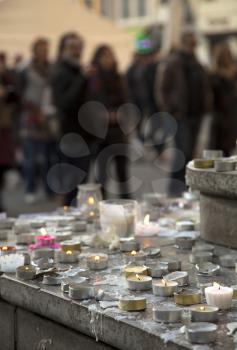 LYON-FRANCE NOVEMBER 15, 2015: People praying and giving offerings, flowers and lighting candles on the steps of the town hall at Lyon, France about the terrorist bombing happens in France on 13th november 2015.