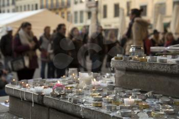 LYON-FRANCE NOVEMBER 15, 2015: People praying and giving offerings, flowers and lighting candles on the steps of the town hall at Lyon, France about the terrorist bombing happens in France on 13th november 2015.