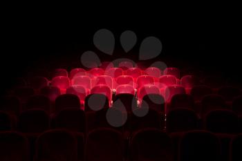 Follow spot on red seat in a generic theater