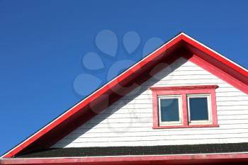 Detail of a red rooftop against a blue sky in Iles de la Madeleine in Canada