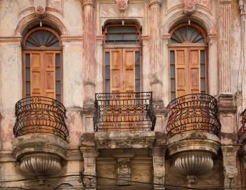 Three beautiful wooden doors with wrought iron staircase colonial style in Havana in Cuba