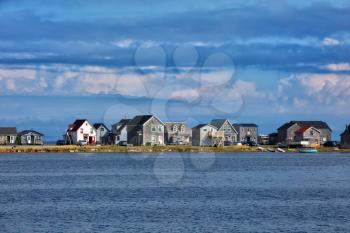 Beautiful houses along the water of Havre aubert  in magdalen island in Quebec, Canada