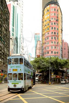 HONG KONG, CHINA-February 27, 2019: The first double-decker buses in was introduced in 1949.  Pale blue double deck bus a pink building in background