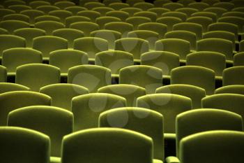 Side view of a green velvet seat in a theatre or a cinema