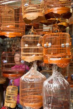 Copper cages hang up in a store market in Hong Kong