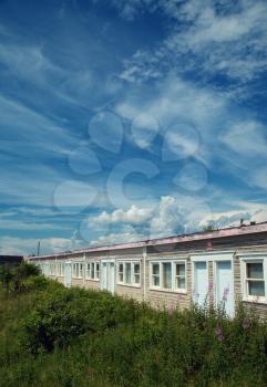 Abandoned motel in a countryside with a blue sky full of clouds 