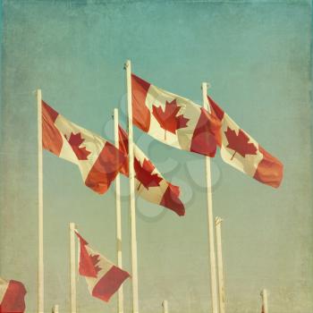 Canadian flags.  Cross processed to look like a vintage picture with texture.