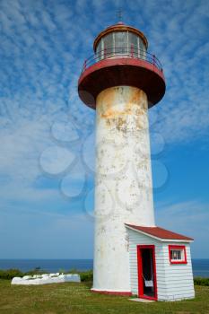 The Cap Madeleine lighthouse in Gaspesie, Quebec, Canada in a blue sky