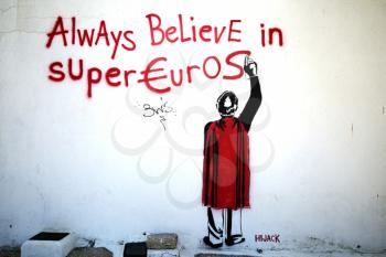 PAROS, GREECE-OCT 18, 2015: Graffiti concerning the crisis in Greece find on a wall saying always believe in super Euros The Greek government-debt crisis started in late 2009. It was the first of five sovereign debt crises in the eurozone  later referred to collectively as the European debt crisis