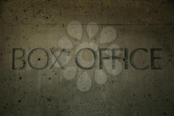 Box office engraved into cement on a wall