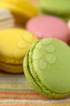 Close up of a  traditional french macaroons in green, yellow, and pink
