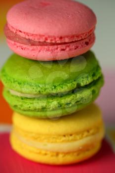 Three tasty macaroons on colourful background