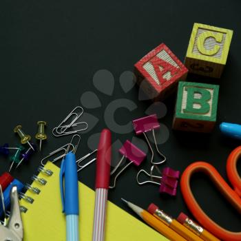 School supplies on a black chalkboard