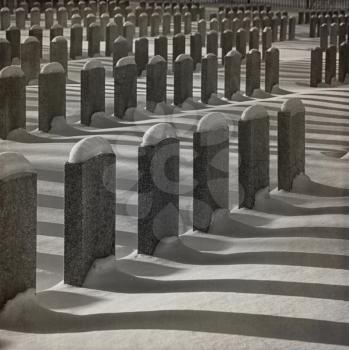 Identical soldier graves and their shadow  during winter season in black and white. Instagram style picture.