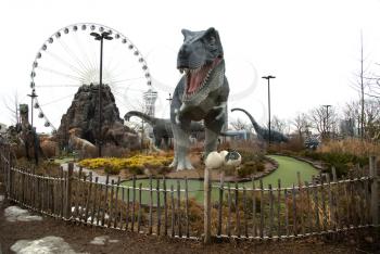 NIAGARA FALLS, CANADA-JANUARY 11, 2016:  Replica of a T-Rex dinosaur and others in a mini putt  golf at Niagara falls in Ontario, Canada